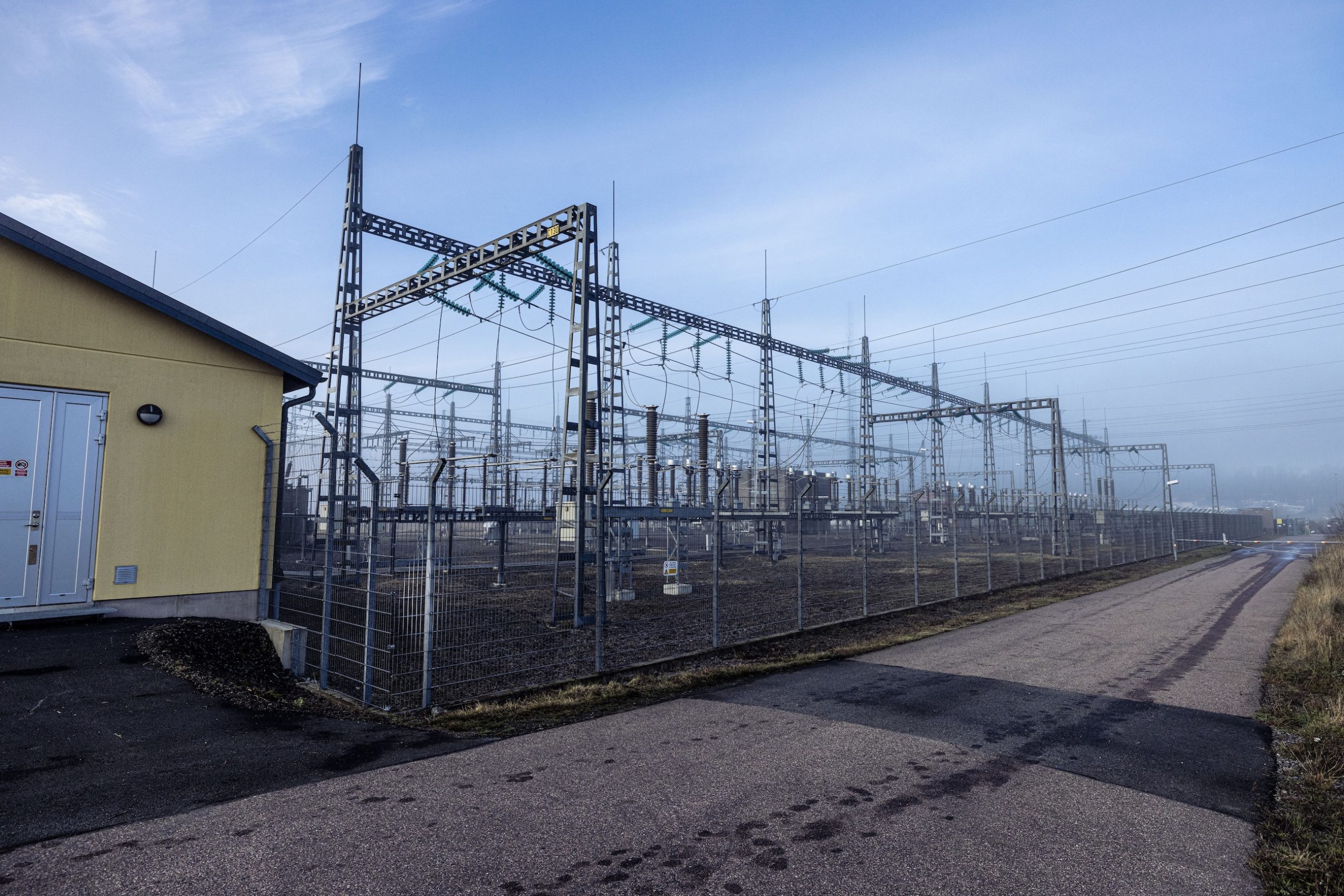 Overhead power lines crossing woodland